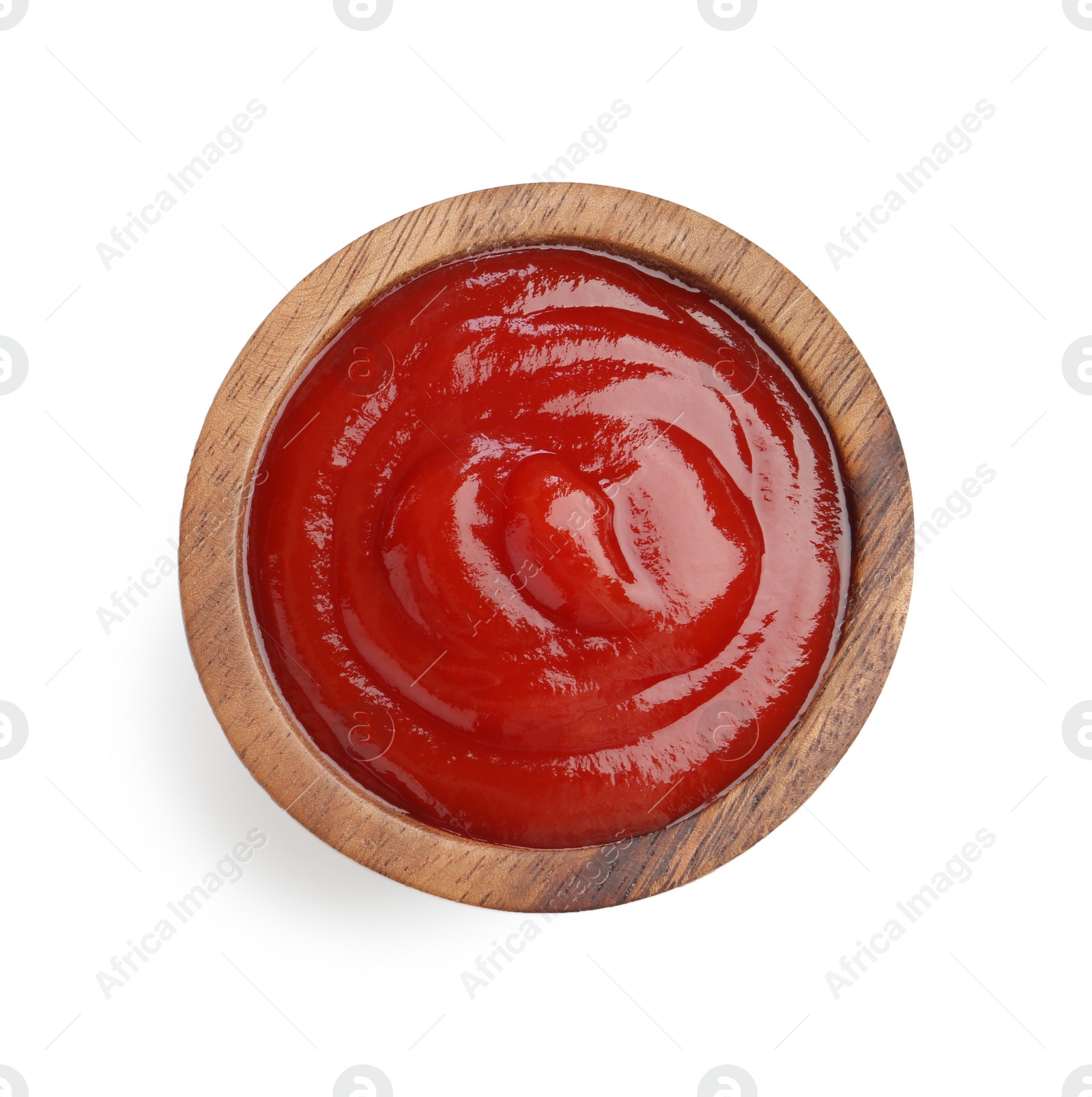 Photo of Tasty ketchup in wooden bowl isolated on white, top view. Tomato sauce