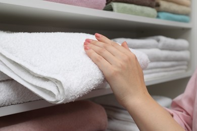 Customer choosing towel in linen shop, closeup