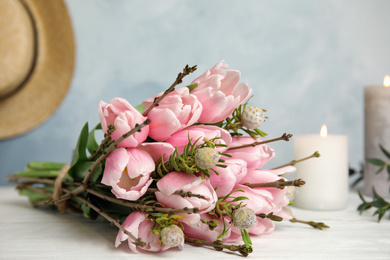 Beautiful bouquet with spring pink tulips on table, closeup