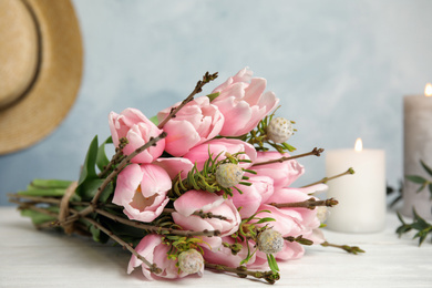 Photo of Beautiful bouquet with spring pink tulips on table, closeup