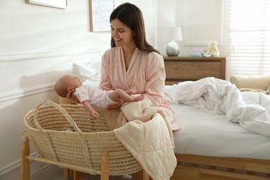 Photo of Happy young mother with her cute newborn baby in bedroom