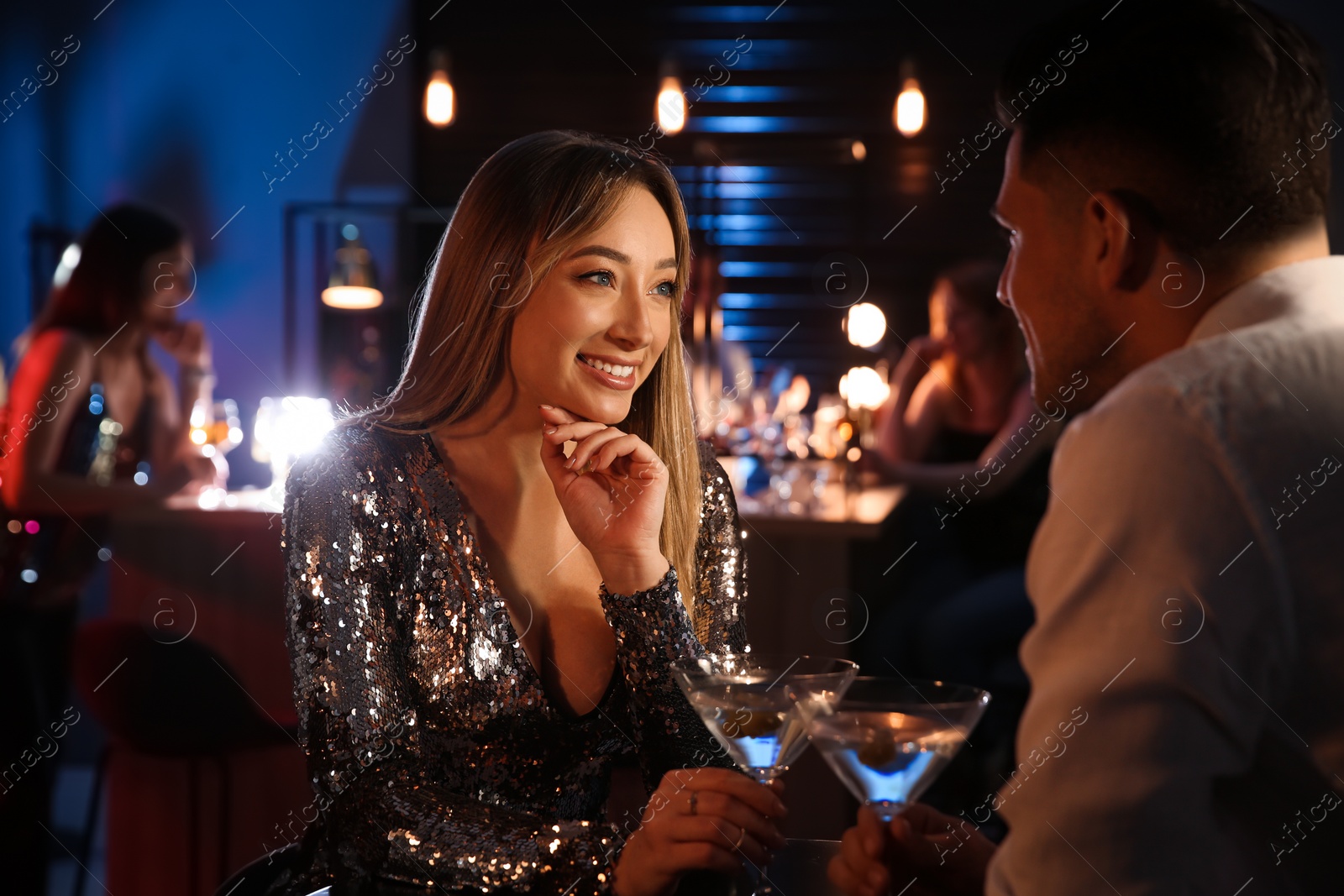 Photo of Man and woman flirting with each other in bar