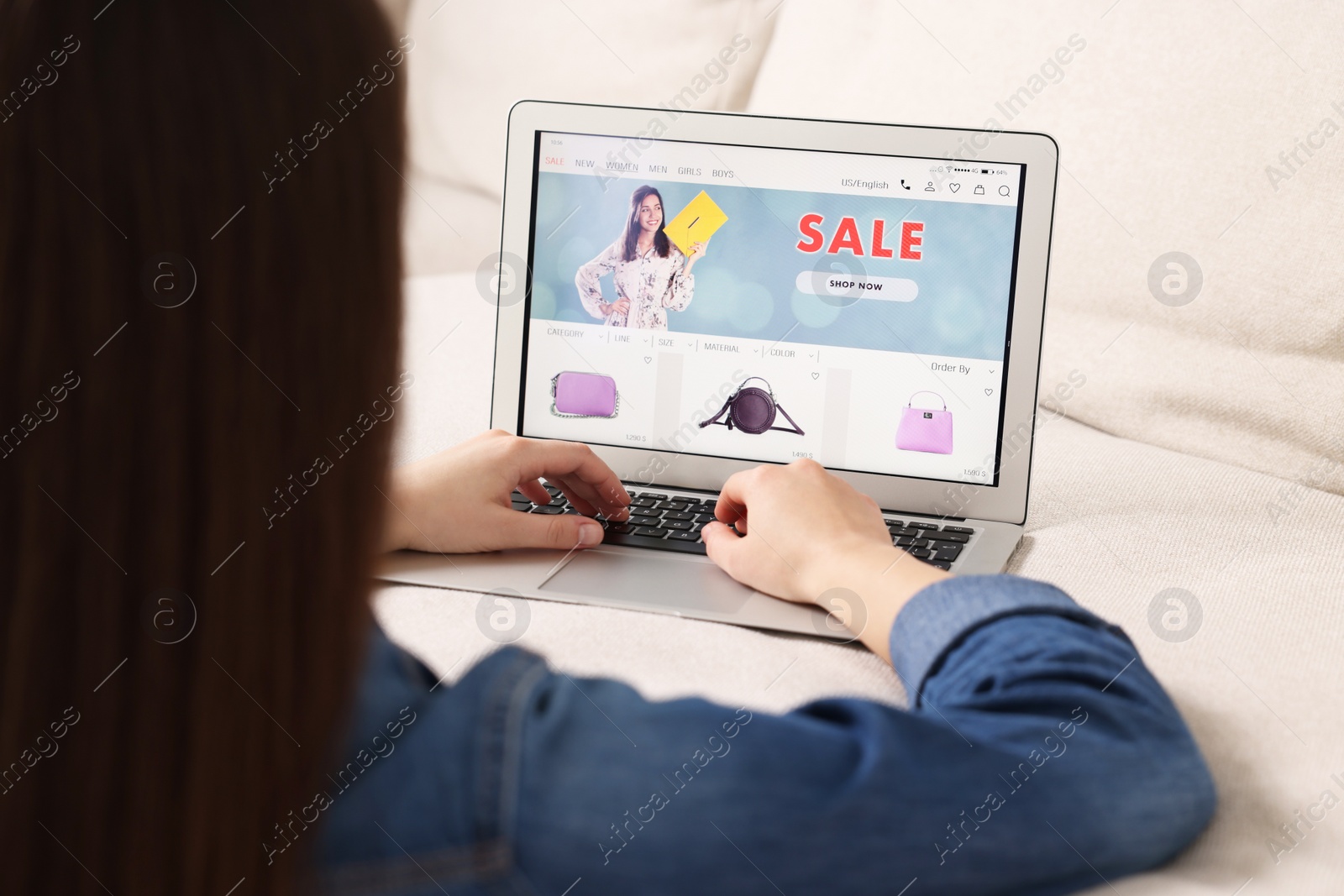 Photo of Woman shopping online during sale on laptop at home, closeup