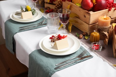 Photo of Beautiful autumn place setting with blank cards and decor on table