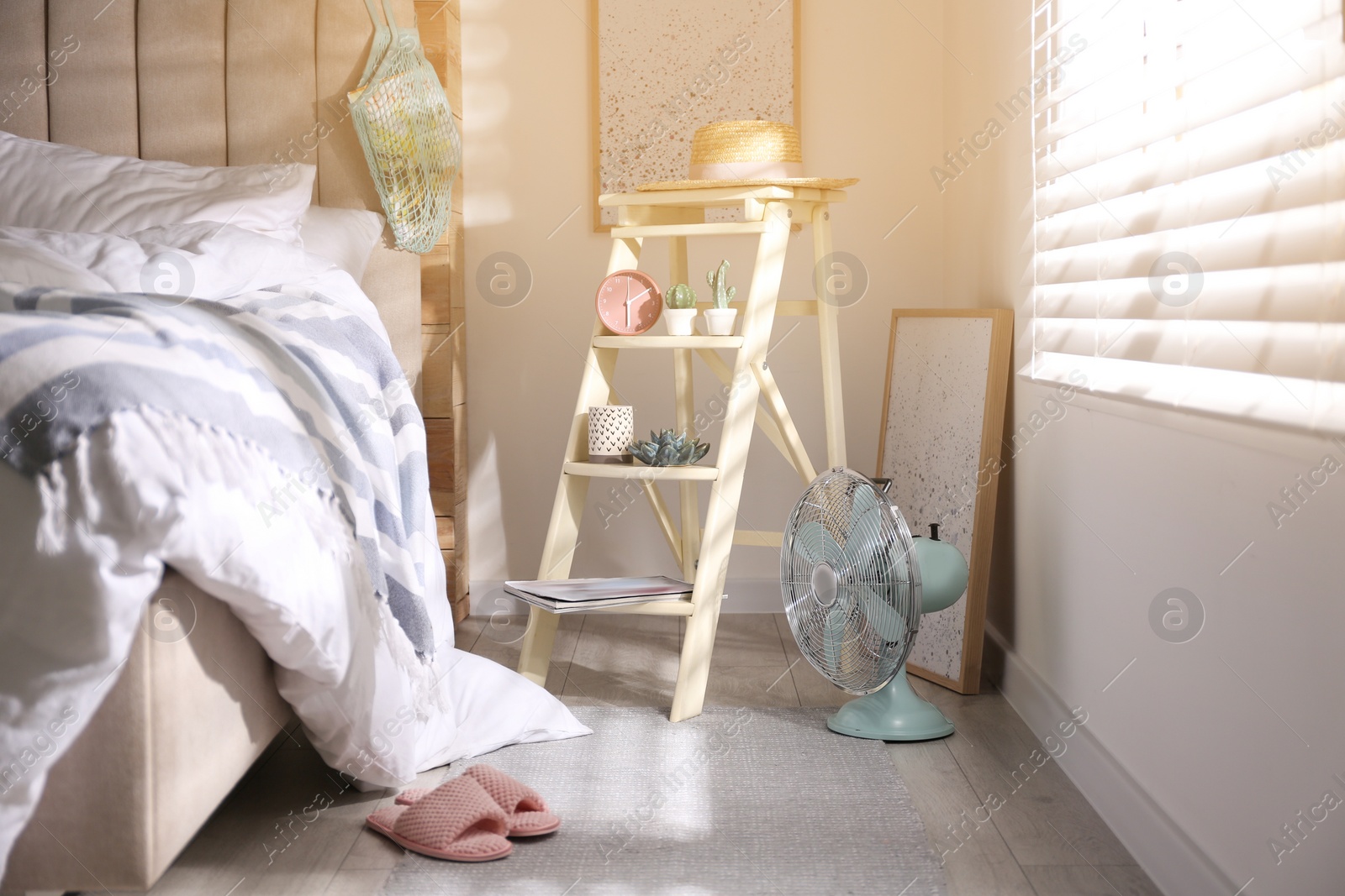 Photo of Decorative ladder with different stuff in stylish bedroom. Idea for interior design