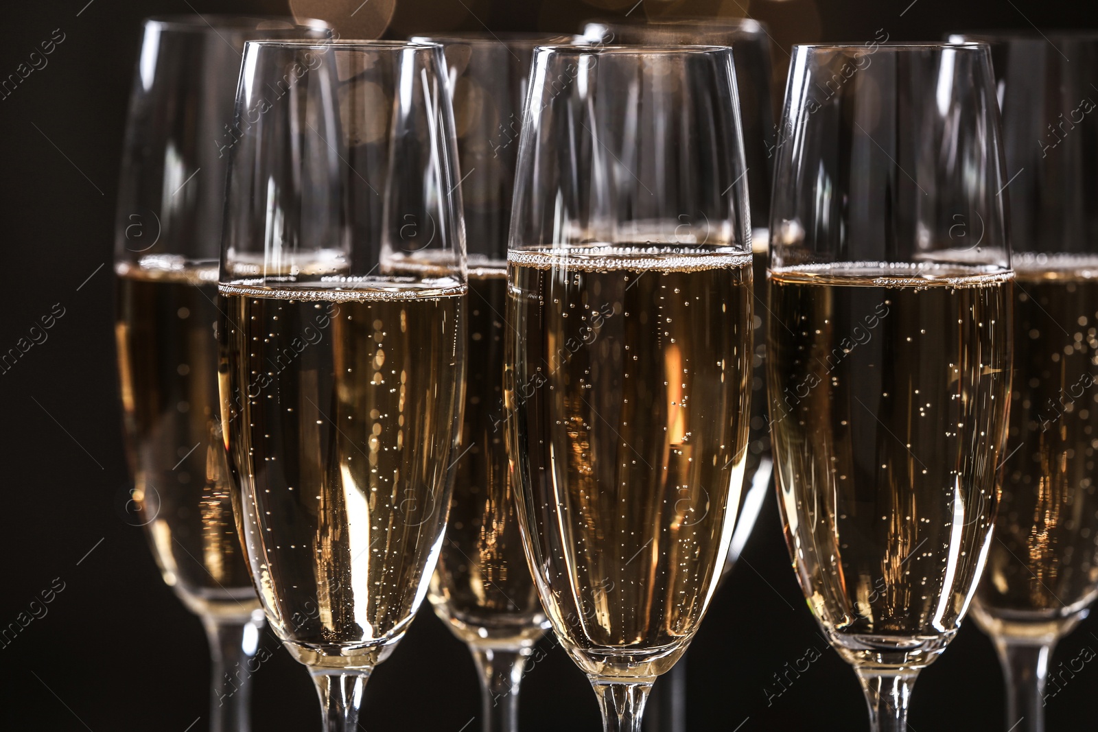 Photo of Glasses of champagne on dark background, closeup