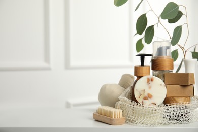 Photo of Eco friendly personal care products on white table indoors, space for text