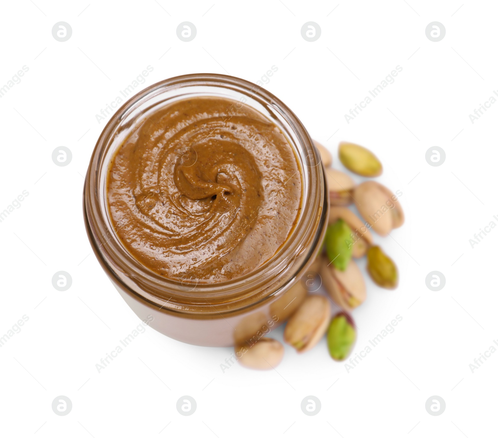 Photo of Tasty nut paste in jar and pistachios isolated on white, top view