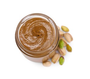 Tasty nut paste in jar and pistachios isolated on white, top view