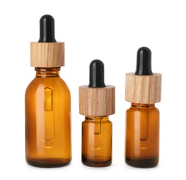 Different bottles of essential oil on white background