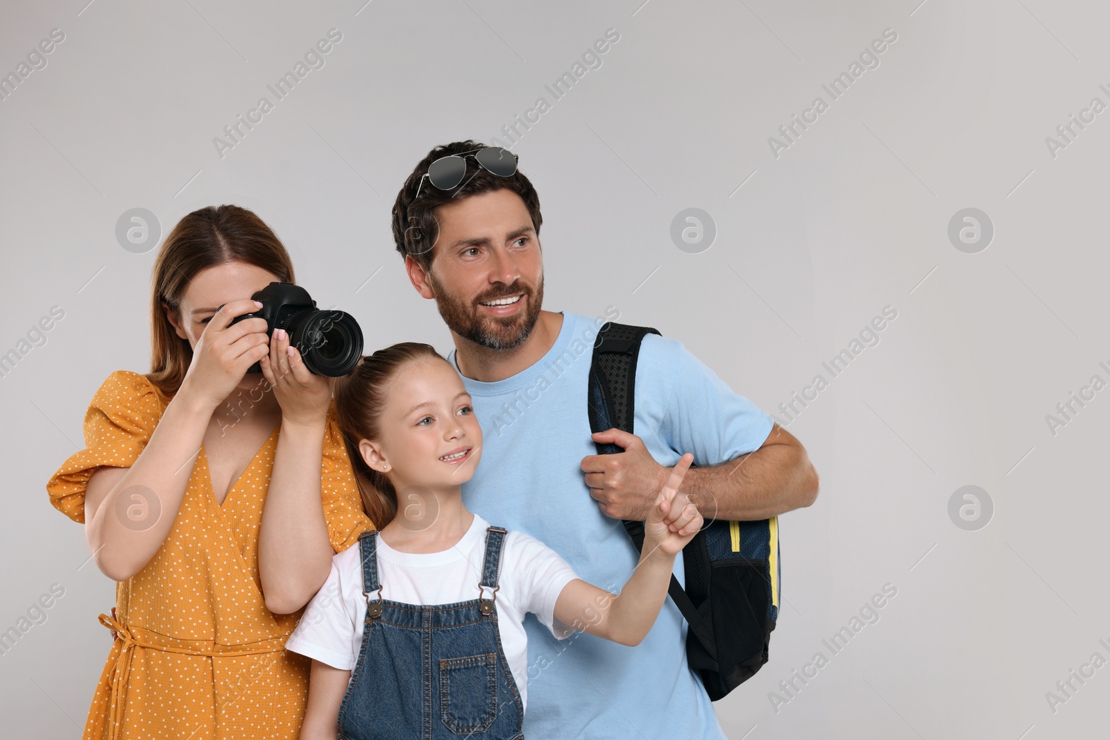 Photo of Happy family making photo on light grey background. Space for text