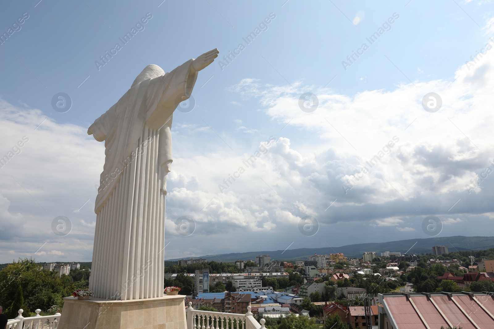 Photo of Truskavets, Ukraine - July 22, 2023: Statue of Christ the Redeemer against beautiful cityscape