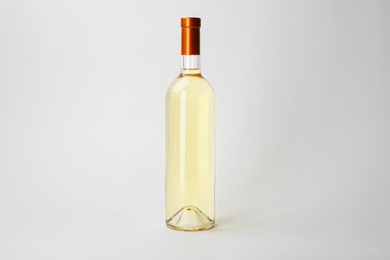 Bottle of expensive wine on white background