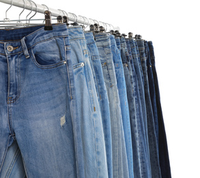 Photo of Rack with different jeans isolated on white