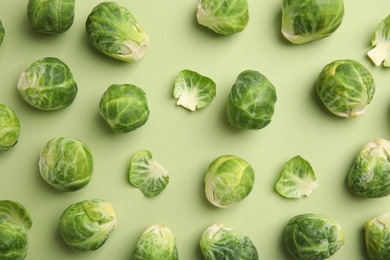 Fresh Brussels sprouts on green background, flat lay