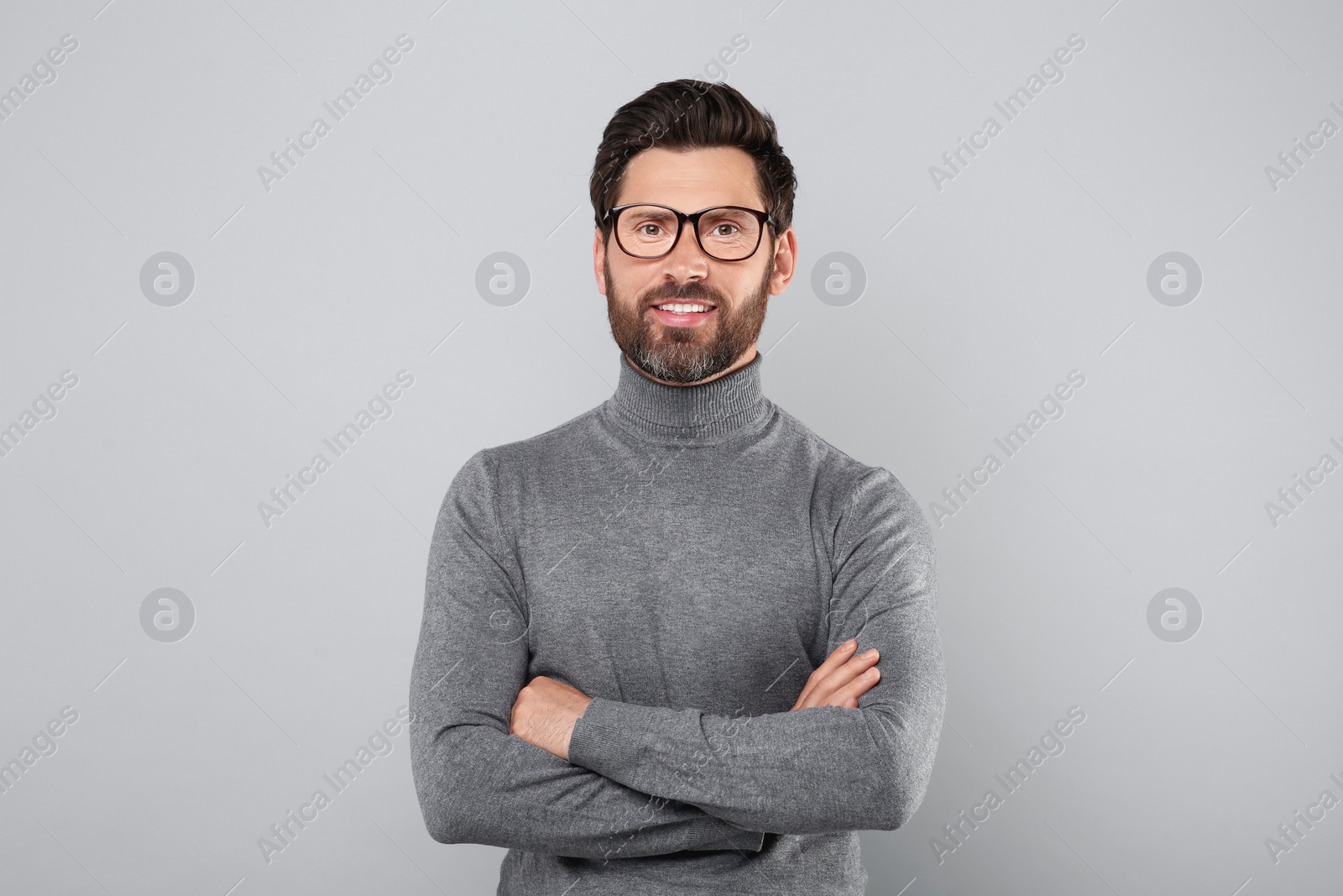 Photo of Portrait of handsome man in glasses on light grey background