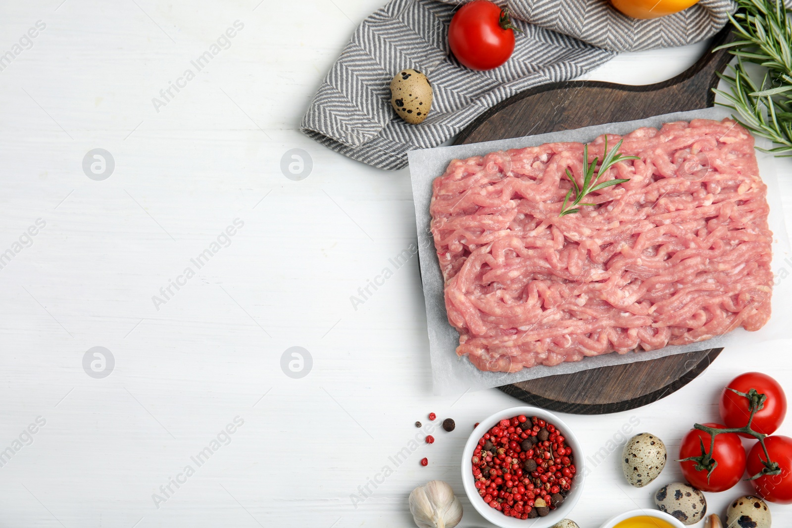 Photo of Raw chicken minced meat and ingredients on white wooden table, flat lay. Space for text