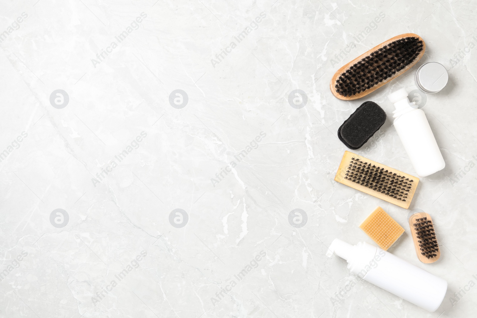 Photo of Flat lay composition with shoe care accessories on light grey background, space for text