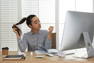 Lazy employee wasting time at table in office