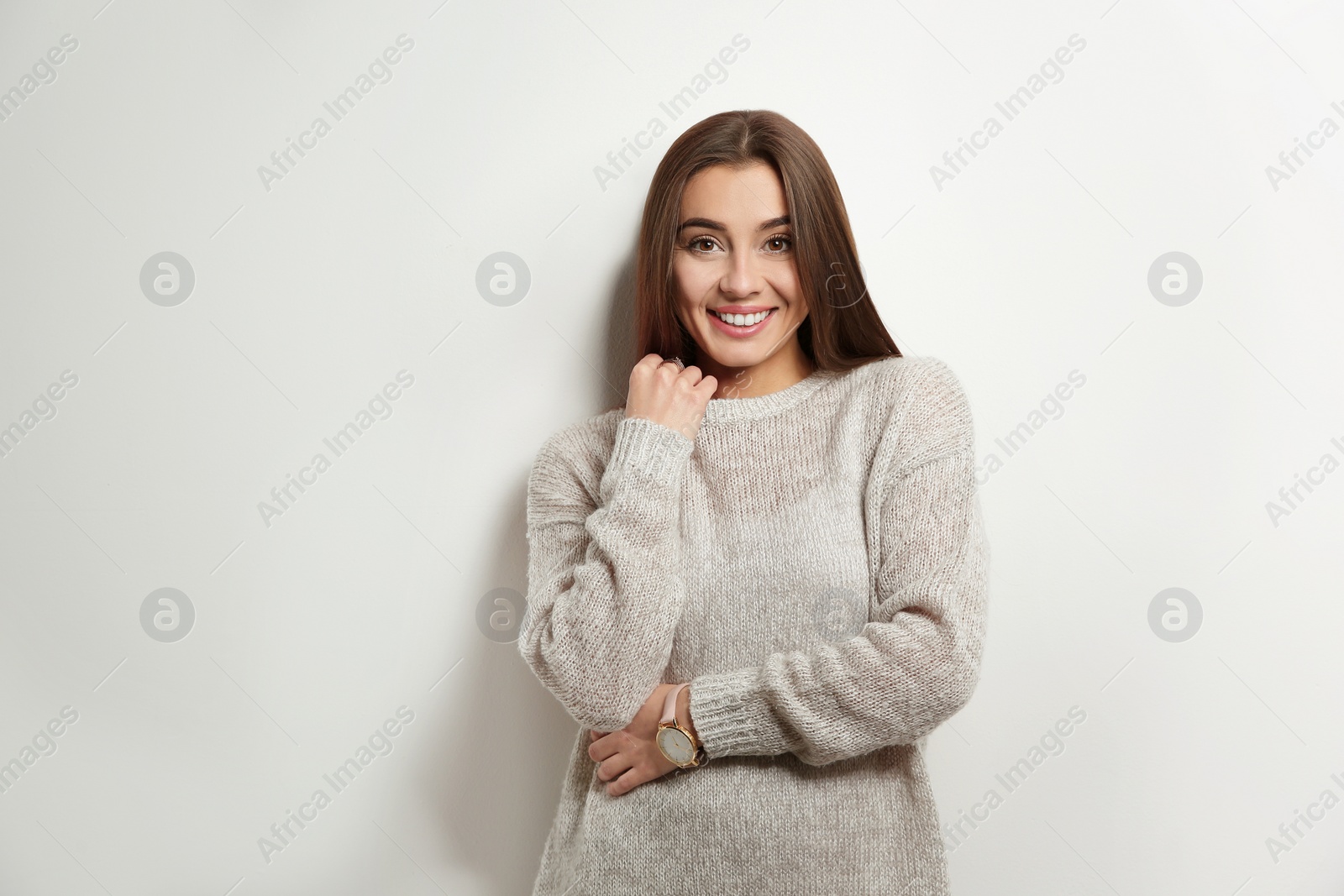 Photo of Beautiful young woman in warm sweater on white background