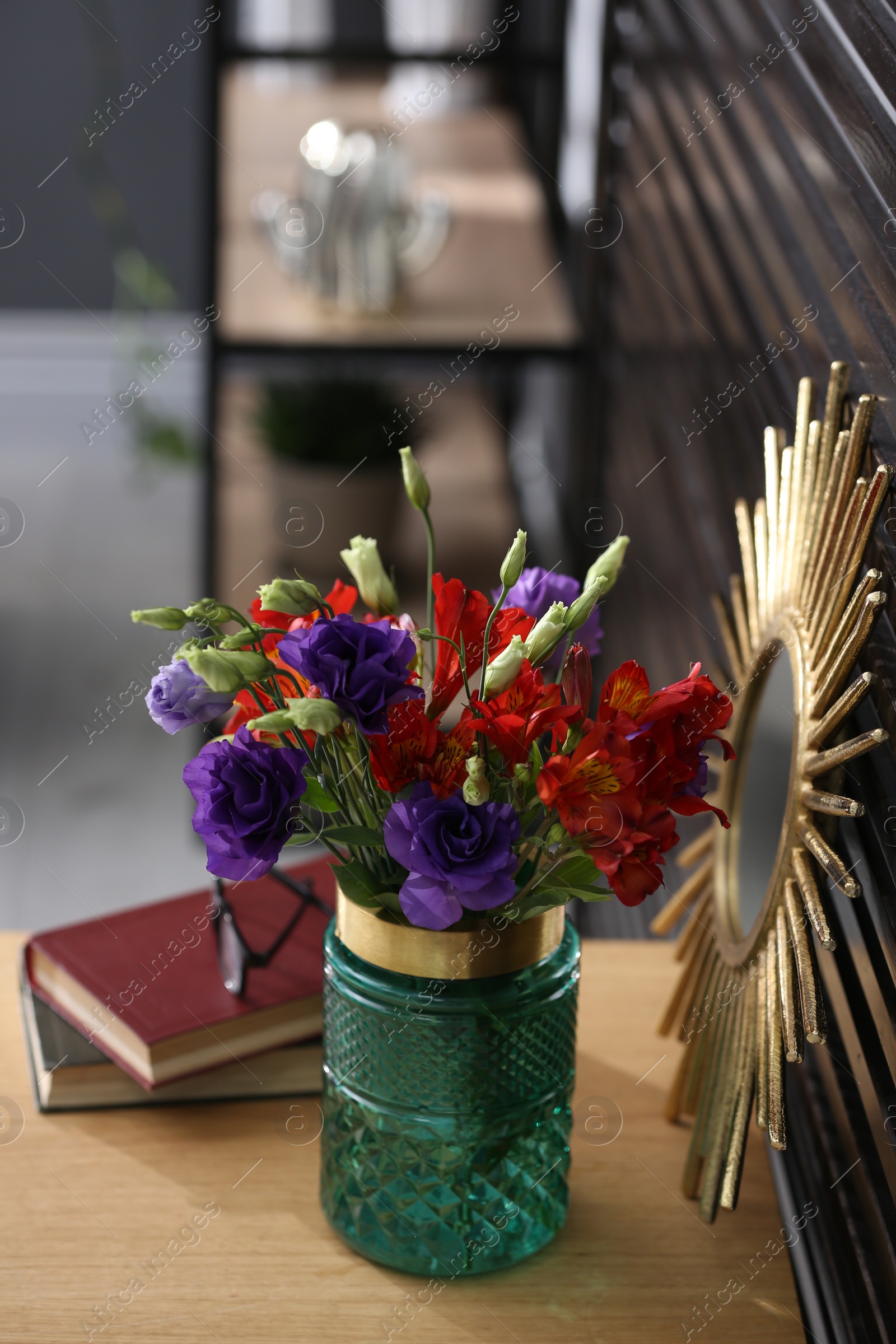Photo of Glass vase with fresh flowers on wooden table