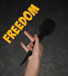 Image of Freedom of speech. Woman with microphone on gray textured background, closeup