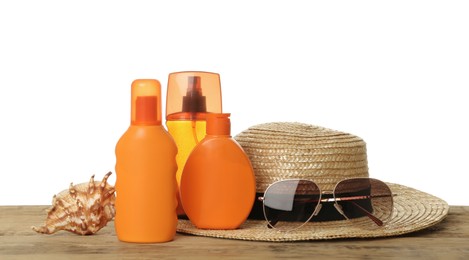 Photo of Sun protection products and beach accessories on wooden table