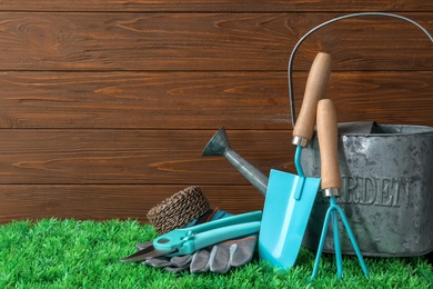 Photo of Set of professional gardening tools on artificial grass