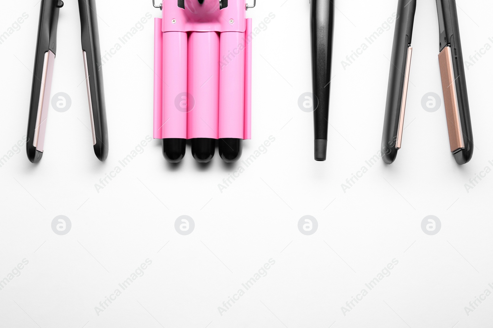 Photo of Set of modern hair irons on white background, top view