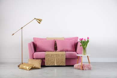 Photo of Modern living room interior with stylish pink sofa. Space for text