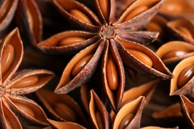 Photo of Many aromatic anise stars on table, closeup