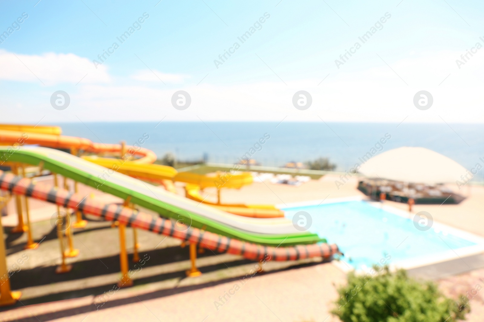 Photo of Different colorful slides in water park, blurred view