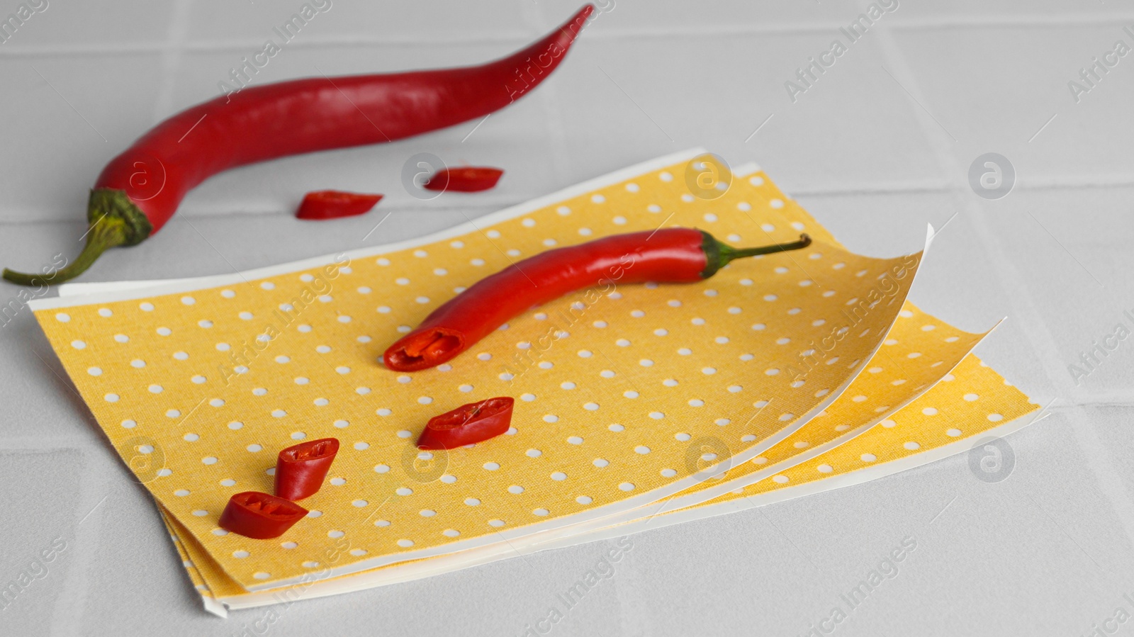 Photo of Pepper plaster and chili on white tiled table, closeup