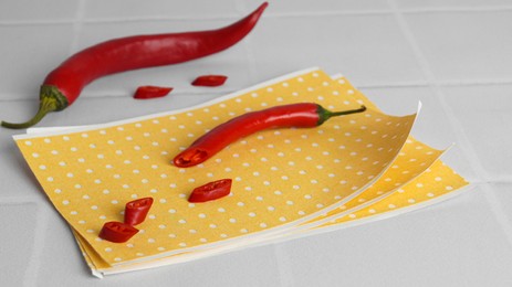 Pepper plaster and chili on white tiled table, closeup