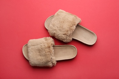 Photo of Pair of soft slippers on red background, flat lay