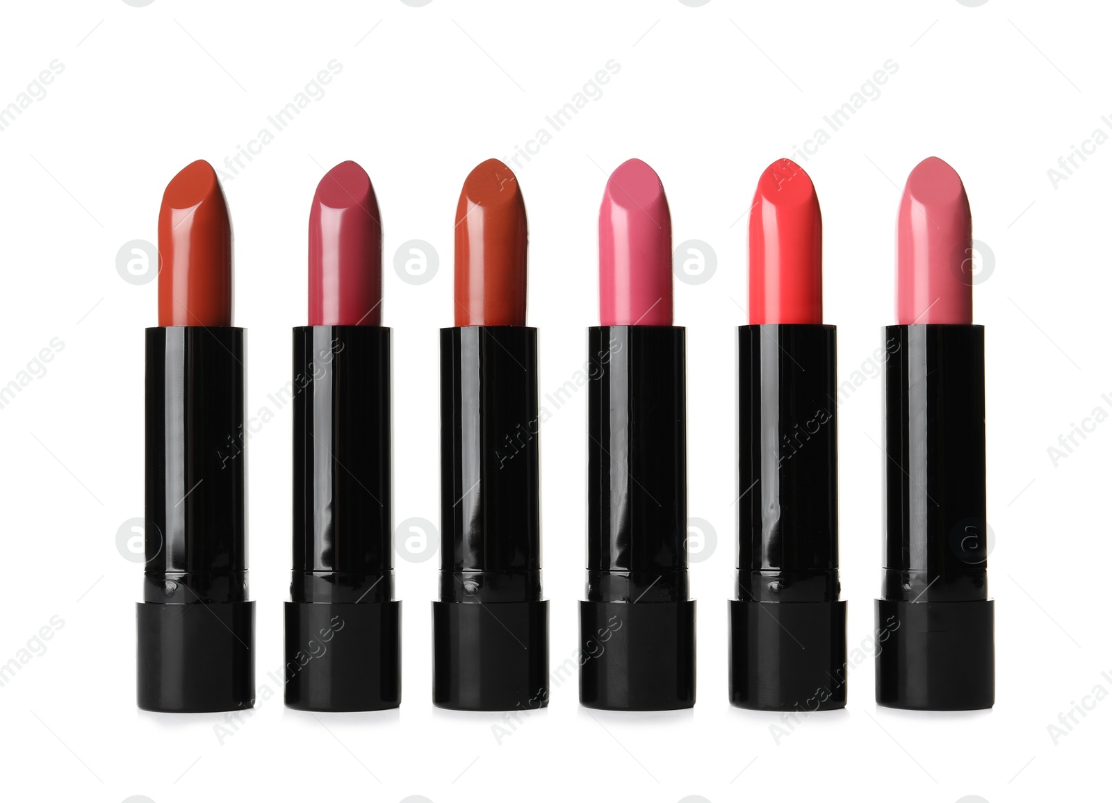 Photo of Different lipsticks on white background. Cosmetic product