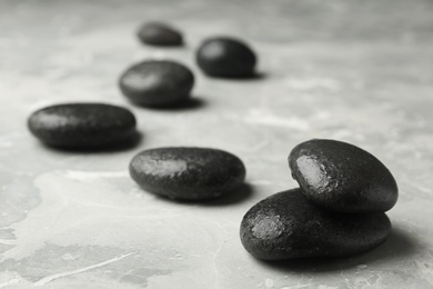 Photo of Wet spa stones on grey background. Space for text