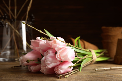 Beautiful bouquet of spring pink tulips on wooden table