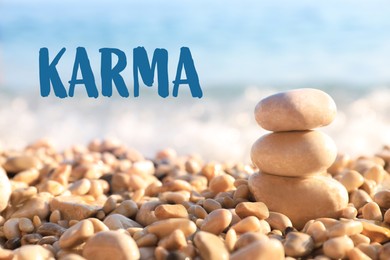 Image of Karma concept. Stack of stones on pebble beach