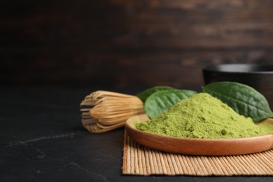 Photo of Green matcha powder, bamboo whisk and leaves, closeup. Space for text