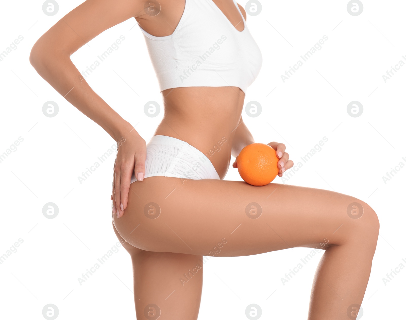 Photo of Closeup view of slim woman in underwear with orange on white background. Cellulite problem concept