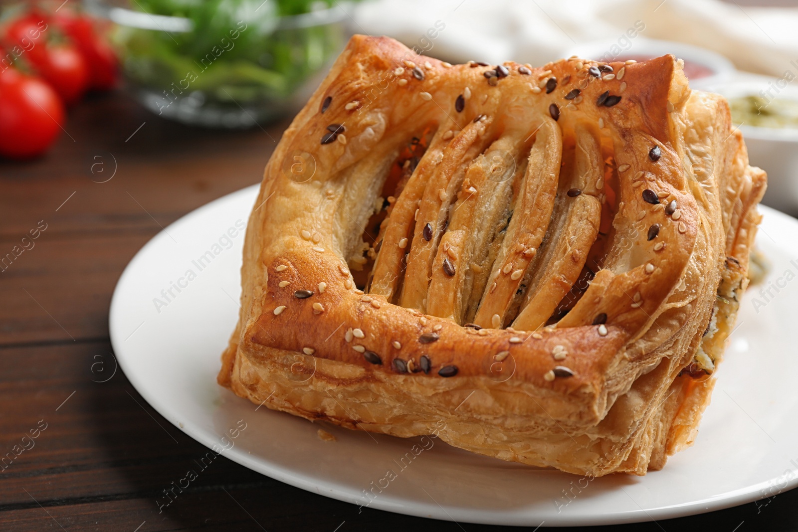 Photo of Fresh delicious puff pastry served on wooden table