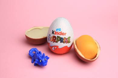 Sveti Vlas, Bulgaria - July 3, 2023: Kinder Surprise Eggs, plastic capsule and toy on pink background