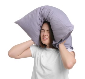 Photo of Tired woman covering ears with pillow on white background. Insomnia problem
