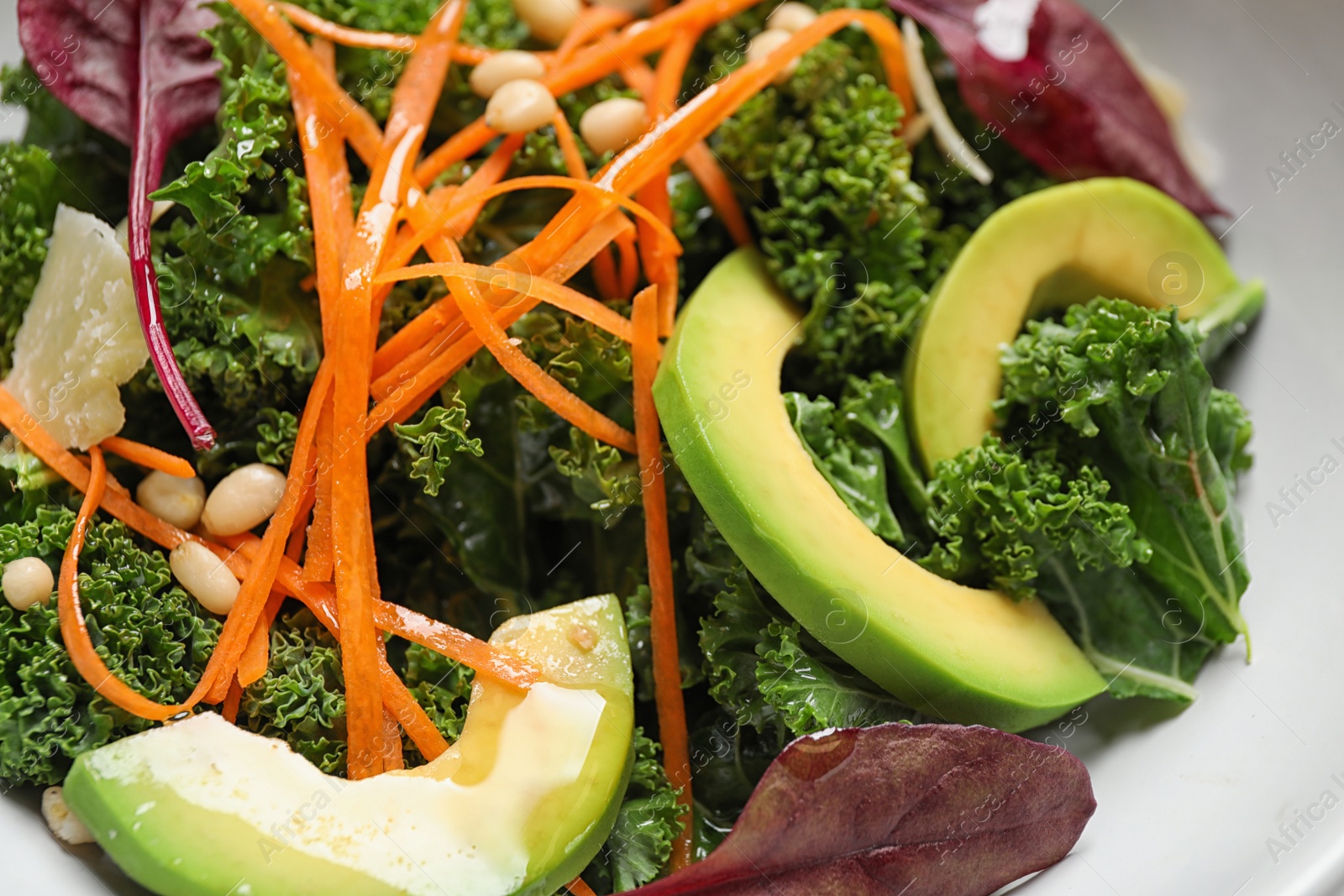 Photo of Tasty fresh kale salad in bowl, closeup