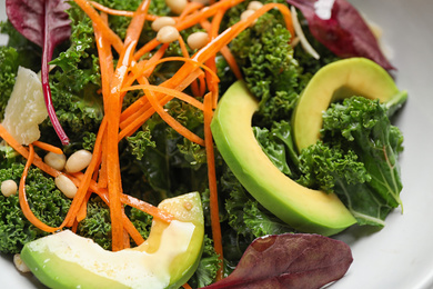 Photo of Tasty fresh kale salad in bowl, closeup