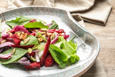 Plate with delicious beet salad on table, closeup