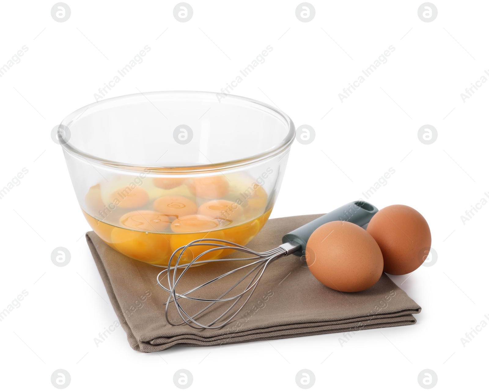 Photo of Whisk, raw eggs and bowl with yolks isolated on white