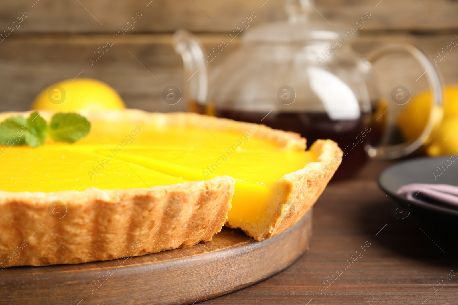 Photo of Delicious homemade lemon pie on wooden table, closeup