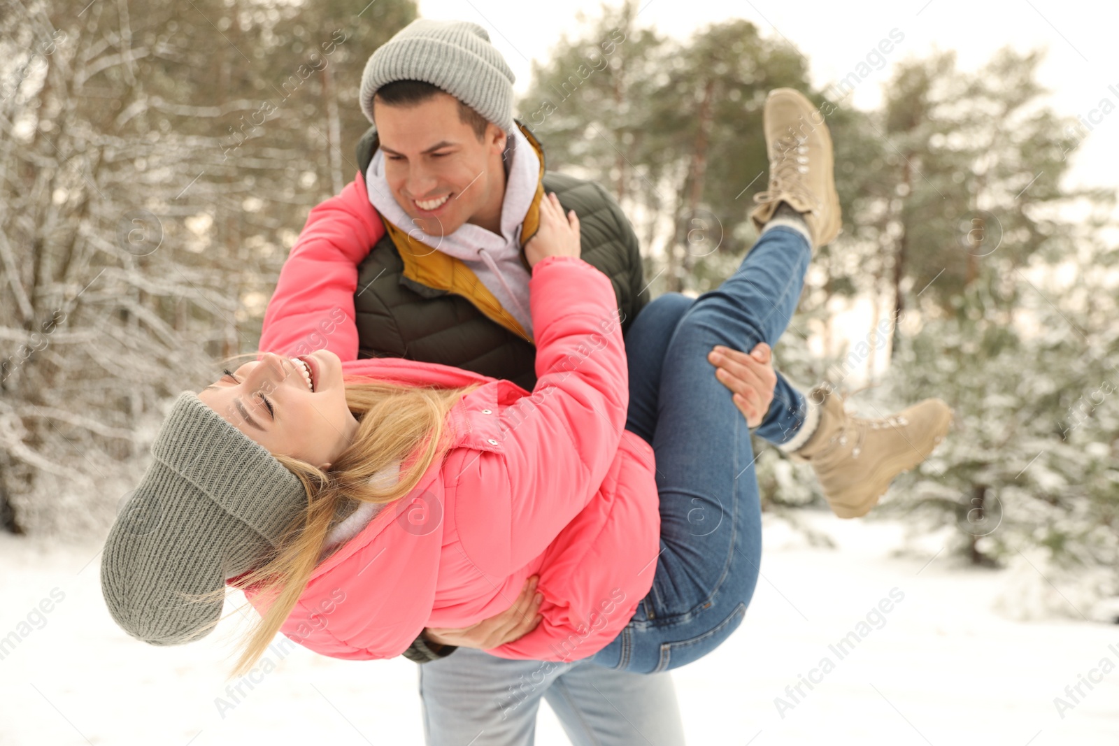 Photo of Beautiful happy couple in snowy forest on winter day